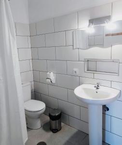 a white bathroom with a toilet and a sink at Montaña Las Tortolas in San Bartolomé +41 photos
