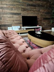 a living room with a couch and a table at Laci Lak Premium apartment in Oradea