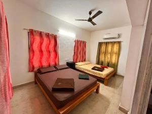 a small room with a bed and a couch at Jamath Villas 1307 in Kīlakarai