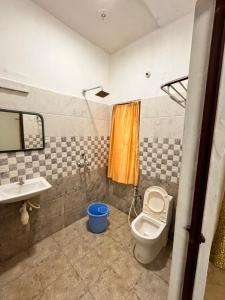 a bathroom with a toilet and a sink at Jamath Villas 1307 in Kīlakarai