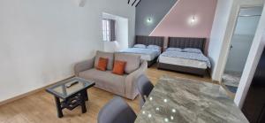 a living room with a couch and a bed at B661 SilverparkResort -walk up in Bukit Fraser