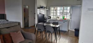 a kitchen with a table and chairs in a room at B661 SilverparkResort -walk up in Bukit Fraser