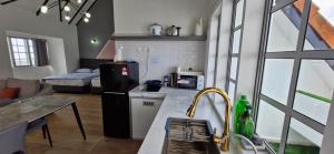 a kitchen with a sink and a kitchen with a bed at B661 SilverparkResort -walk up in Bukit Fraser +33 photos