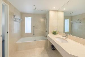 a bathroom with a tub and a sink and a shower at L19 Ocean View Suite - King Bed Wi-Fi in Gold Coast