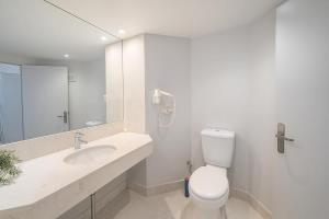 a white bathroom with a toilet and a sink at L19 Ocean View Suite - King Bed Wi-Fi in Gold Coast