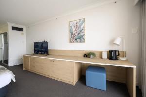 a room with a wooden desk with a blue chair at L19 Ocean View Suite - King Bed Wi-Fi in Gold Coast