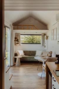 a living room with a couch and a table at Tiny Bali spa house in Menaldum