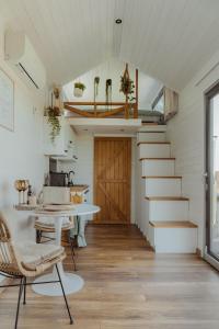a room with stairs and a table and a door at Tiny Bali spa house in Menaldum