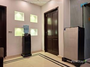 a room with a elevator and a door with lights at Pine Stay Premium 3 Bedroom Furnished Family Home in Lahore