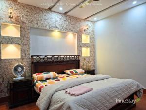 a bedroom with a bed with a large mirror at Pine Stay Premium 3 Bedroom Furnished Family Home in Lahore