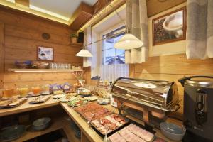 a kitchen with a buffet of food on a counter at Pension and Apartments MONIKA in Špindlerův Mlýn