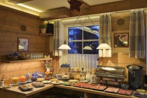 a kitchen with a buffet of food on a counter at Pension and Apartments MONIKA in Špindlerův Mlýn