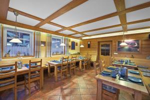 a dining room with wooden tables and chairs at Pension and Apartments MONIKA in Špindlerův Mlýn +39 photos