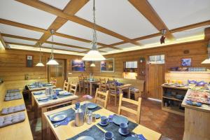 a dining room with wooden tables and chairs at Pension and Apartments MONIKA in Špindlerův Mlýn