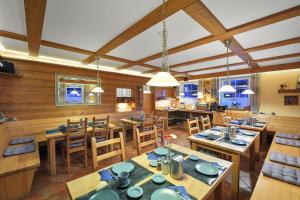 a dining room with wooden tables and chairs at Pension and Apartments MONIKA in Špindlerův Mlýn