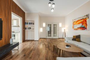 a living room with a couch and a table at The Old-Clock Apartment by PikHost in Shkodër