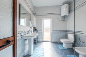 a bathroom with a sink and a toilet and a mirror at The Old-Clock Apartment by PikHost in Shkodër +27 photos