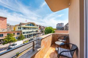a balcony with chairs and a view of a city at The Old-Clock Apartment by PikHost in Shkodër