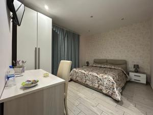 a bedroom with a bed and a table in it at La Suite in Cassino