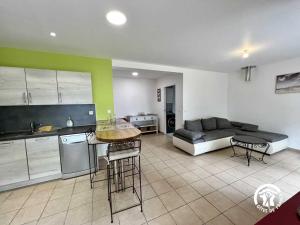 a kitchen and living room with a couch and a table at La calm in Villardonnel +13 photos