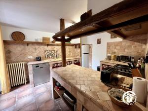 a large kitchen with a counter top in a room at Domaine de la calm in Villardonnel