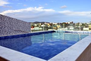 a swimming pool on the roof of a building at Hotel Center Vitoria in Vitória de Santo Antão