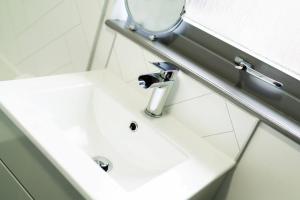 a bathroom sink with a mirror next to it at Ellaburn in Barry +24 photos