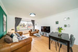 a living room with a couch and a table at Ellaburn in Barry