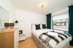 a bedroom with a large bed and a window at Ellaburn in Barry
