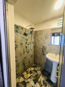 a bathroom with a shower and a sink at Elephant Cabana Udawalawe in Udawalawe
