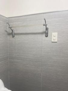 a shower with two faucets in a bathroom at Potot Haven Dorm and Transient in Libmanan