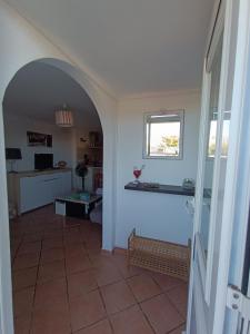 a kitchen with an archway leading into a room with a kitchen at GRANDE PLAGE A 50 Métres in Valras-Plage