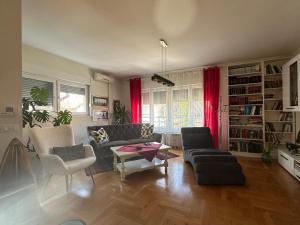 a living room with a couch and a table at Apartman Fenjer in Zagreb