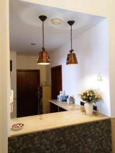 a kitchen with two lights hanging over a counter at Hotel Hanseatic-garni in Wuppertal