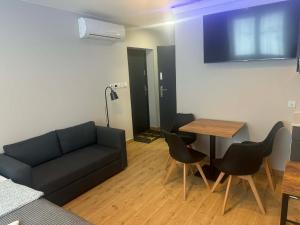 a living room with a couch and a table at Hotel Mis in Bochnia