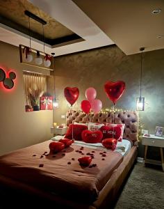 a bedroom with red hearts hanging above a bed at Laci Lak Premium apartment in Oradea