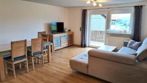 a living room with a couch and a table at FeWo Beim Huber in Hopferau