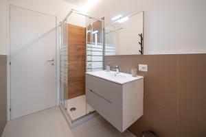 a bathroom with a sink and a shower at Alloggio Primula - Gionic Apartments Bologna in Bologna