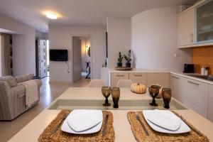 a kitchen and living room with a table and chairs at Carpe Diem Suite in Agios Fokas