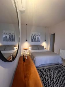 a bedroom with a large bed and a mirror at Carpe Diem Suite in Agios Fokas