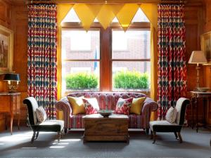 a living room with a couch and two chairs at Covent Garden Hotel, Firmdale Hotels in London