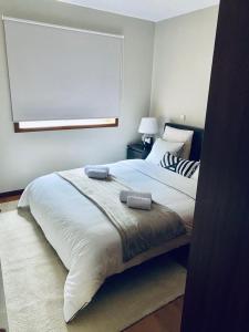 a bedroom with a large bed and a window at Villas do monte in Guimarães +18 photos
