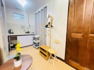 a living room with a table and a chair at Potot Haven Dorm and Transient in Libmanan +9 photos