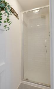 a shower with a glass door in a bathroom at 2 Bed in Swanage oc-wy460 in Swanage