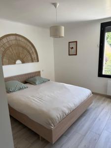 a bedroom with a large bed in a room at Le Foirail in Nasbinals