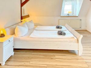 a bedroom with a bed with towels on it at GurkenLoft in Lübbenau