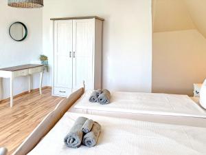 a bedroom with two beds with towels on them at GurkenLoft in Lübbenau