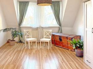 a room with two chairs and a wooden chest at GurkenLoft in Lübbenau +32 photos