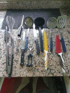 a bunch of kitchen utensils sitting on a counter at Ecotropicfarmhouse in Cerro Azul
