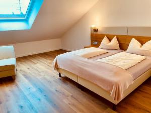 a bedroom with a large bed and a window at Brandmayerhof in Oberding